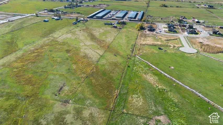 Expansive undeveloped land featuring natural grasses and perimeter fencing