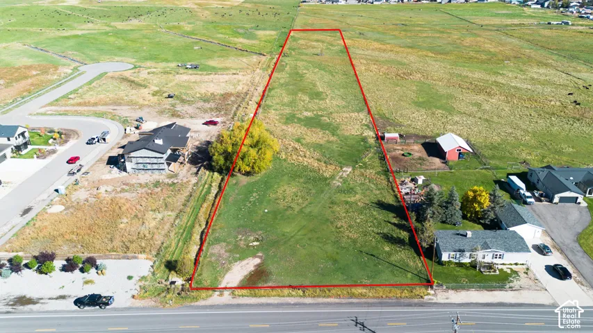 Expansive vacant land featuring approximately 2.5 acres of level terrain with mature landscaping and established trees