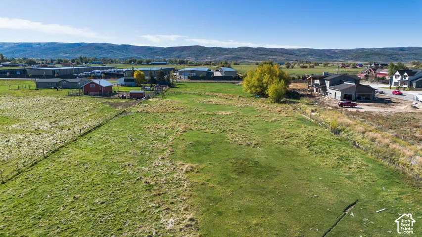 Expansive green acreage with distant mountain scenery