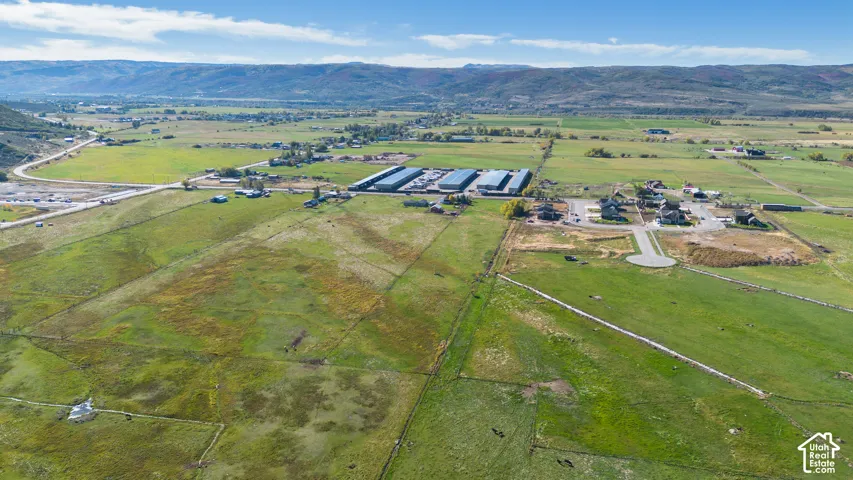 Expansive green fields with a cul-de-sac and developing residential area