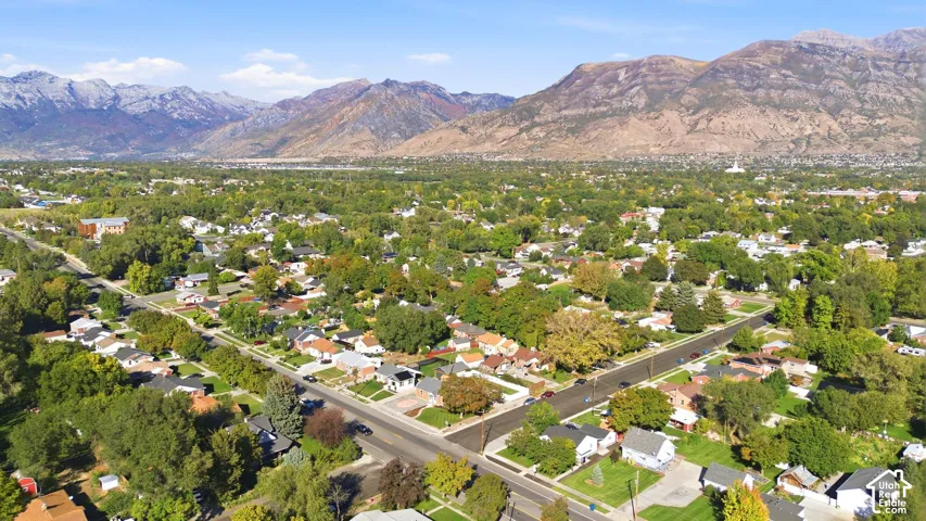 Mountain backdrop with a residential community featuring mature trees and street-lined homes