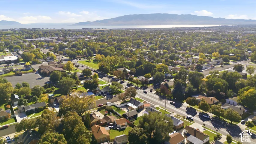 Expansive treed neighborhood with a prominent Utah lake and distant mountains