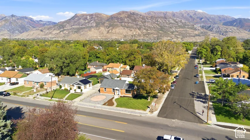 Residential area with established trees and mountain backdrop