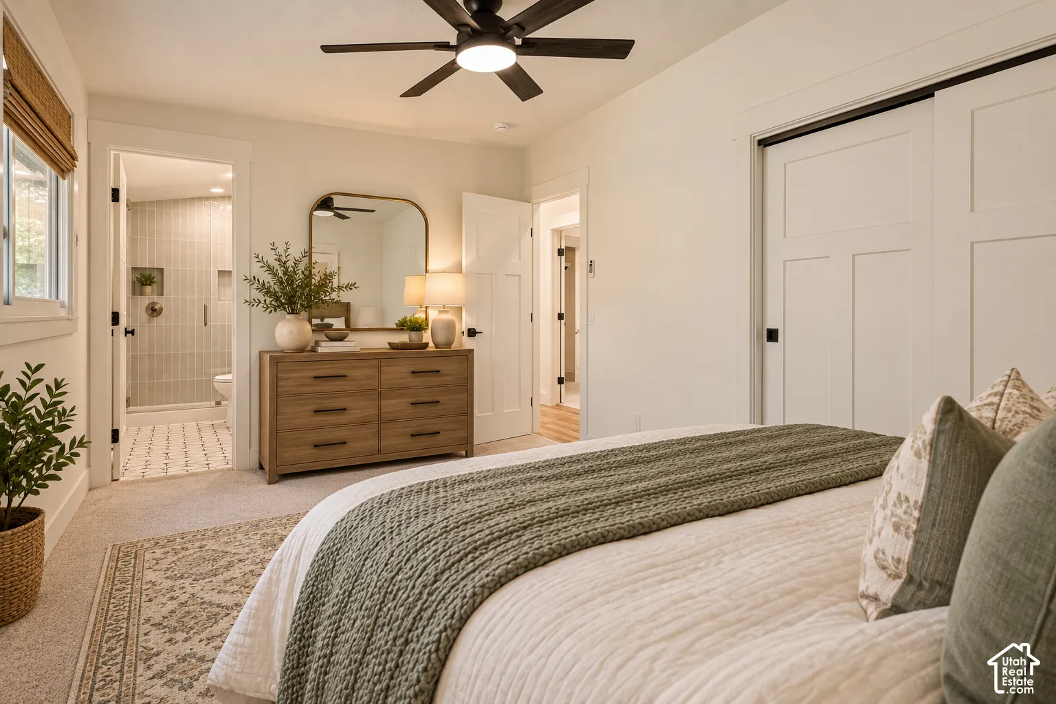 Recessed lighting, ceiling fan, and sliding closet doors with black hardware