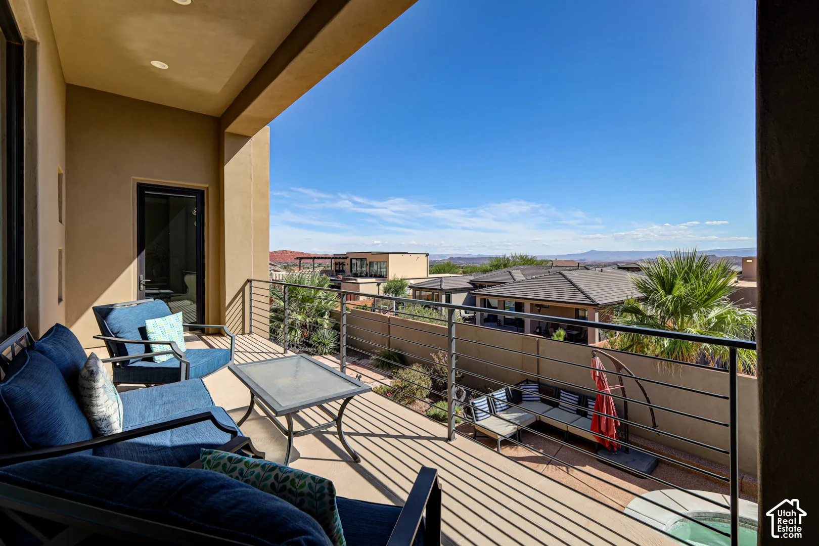 Expansive balcony with exterior lighting and a sliding glass door