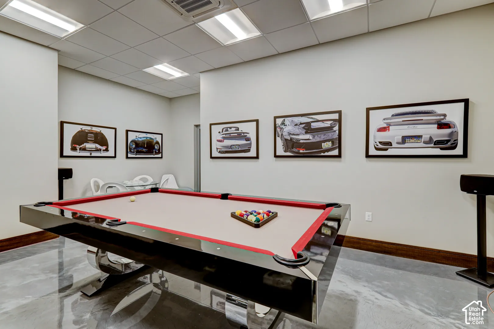 Polished concrete flooring, recessed lighting, and a drop ceiling with integrated lighting