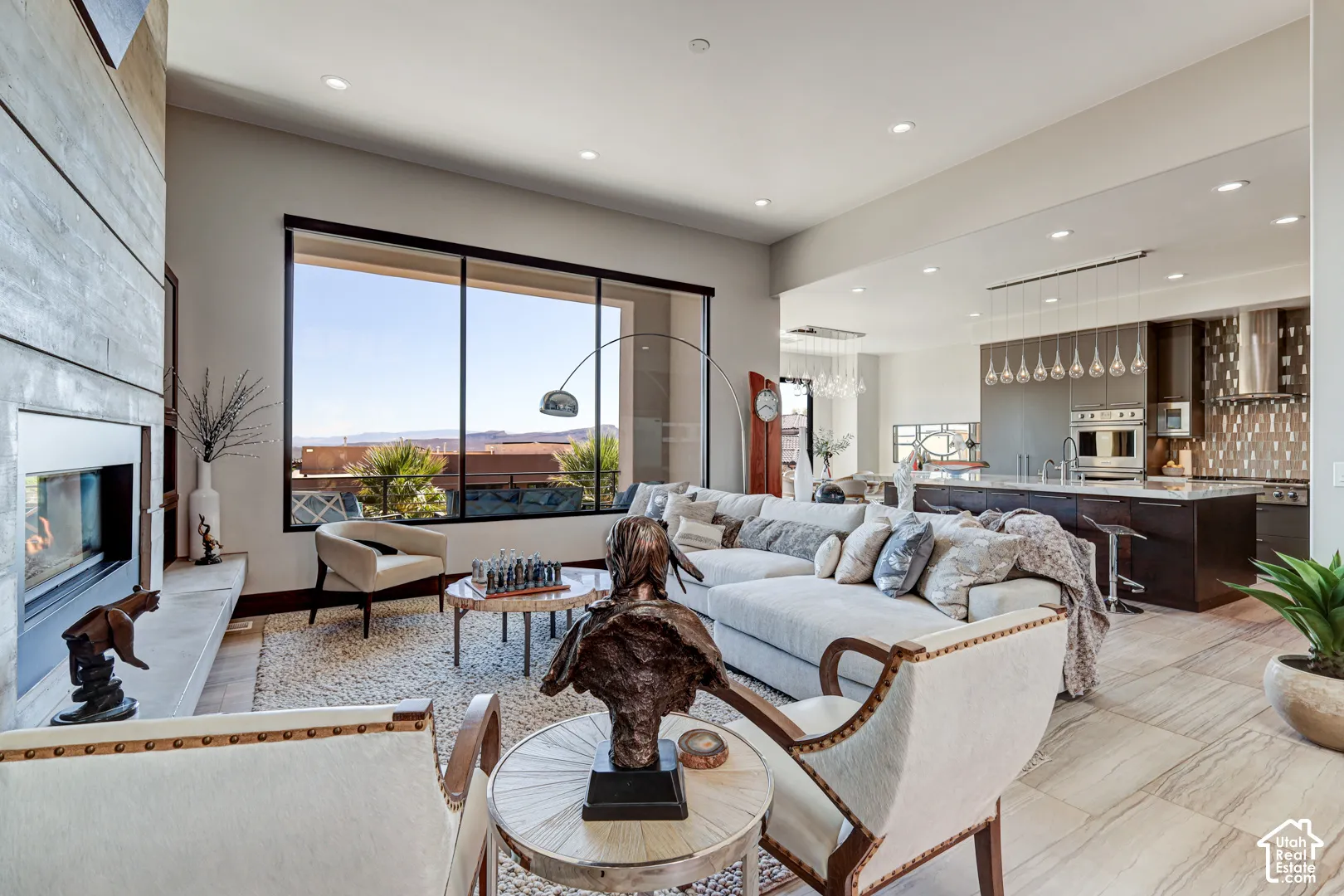 Open concept living space featuring a linear fireplace, large picture window, recessed lighting, and tile flooring