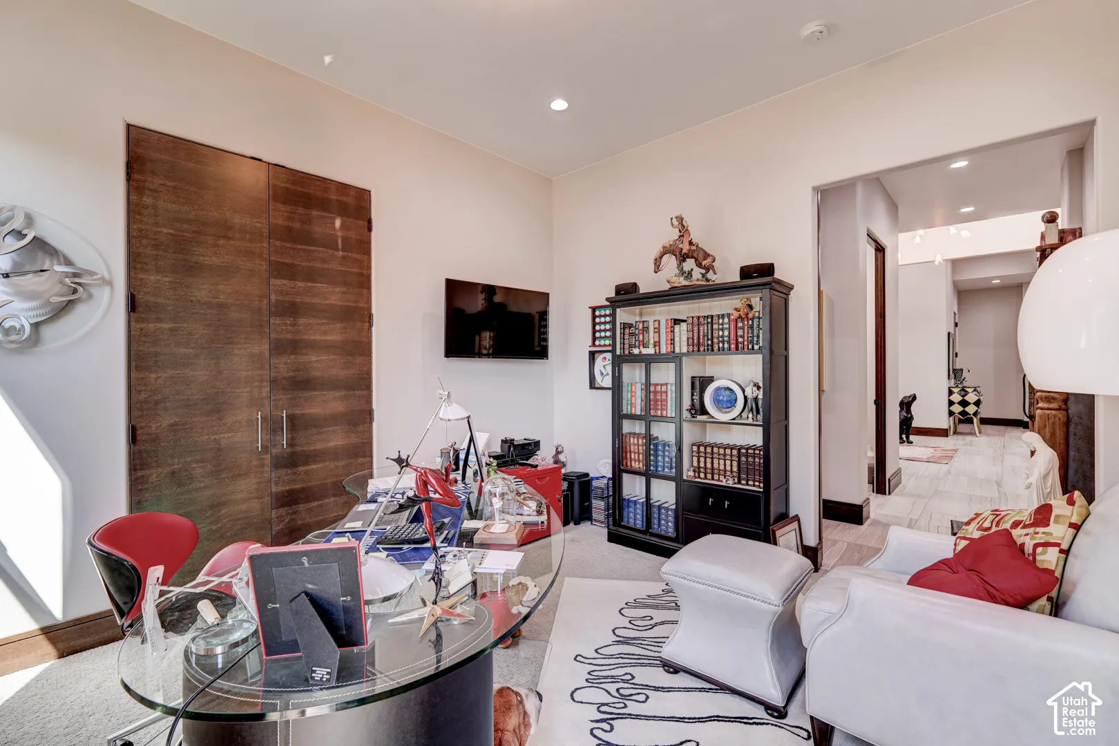 Recessed lighting, wood-finish bi-fold doors, and light-toned wall paint