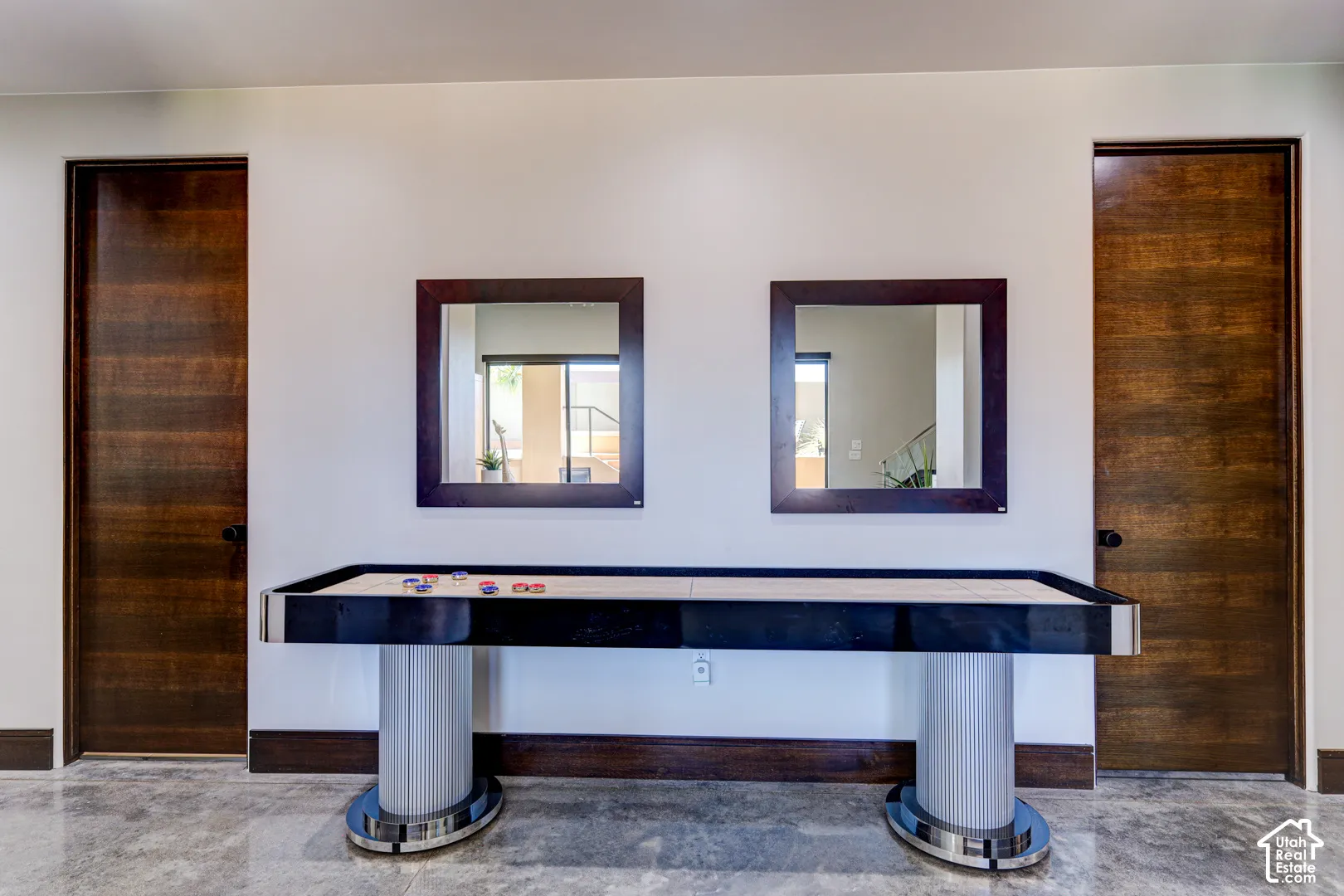 Wood-finish doors, two framed mirrors, and light-colored wall paint
