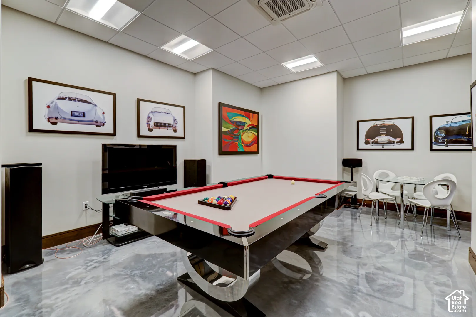 Recessed ceiling lighting, white ceiling tiles, light-toned walls, and a glossy, reflective flooring surface
