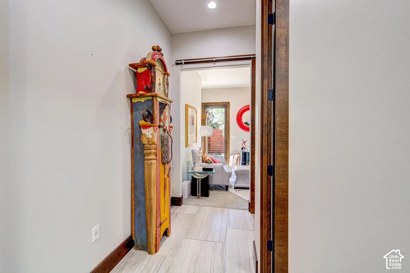 Hallway featuring wood-finish flooring, recessed lighting, and a wood-framed doorway