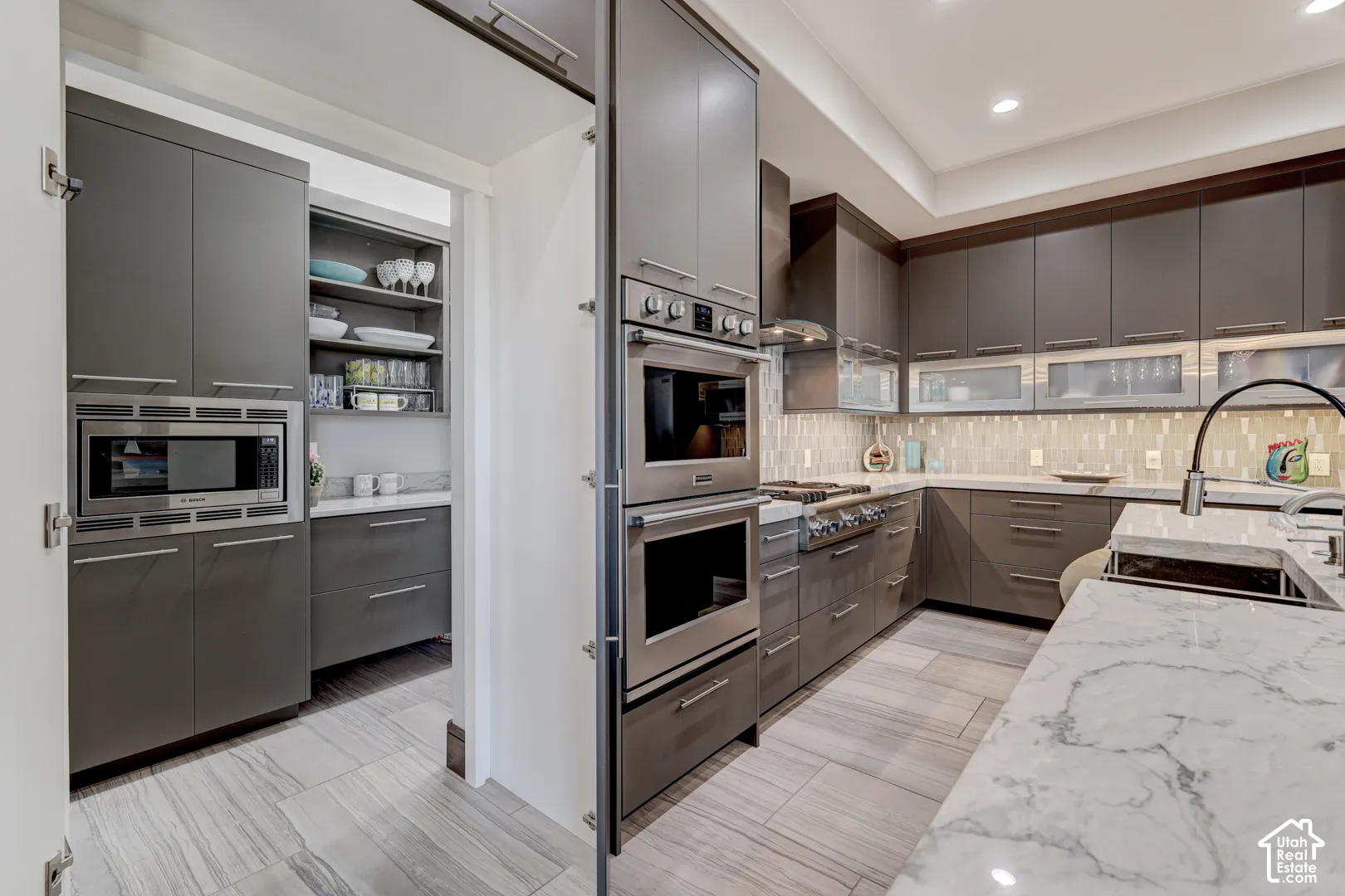 Gourmet kitchen with custom cabinetry, integrated double ovens, and a built-in microwave