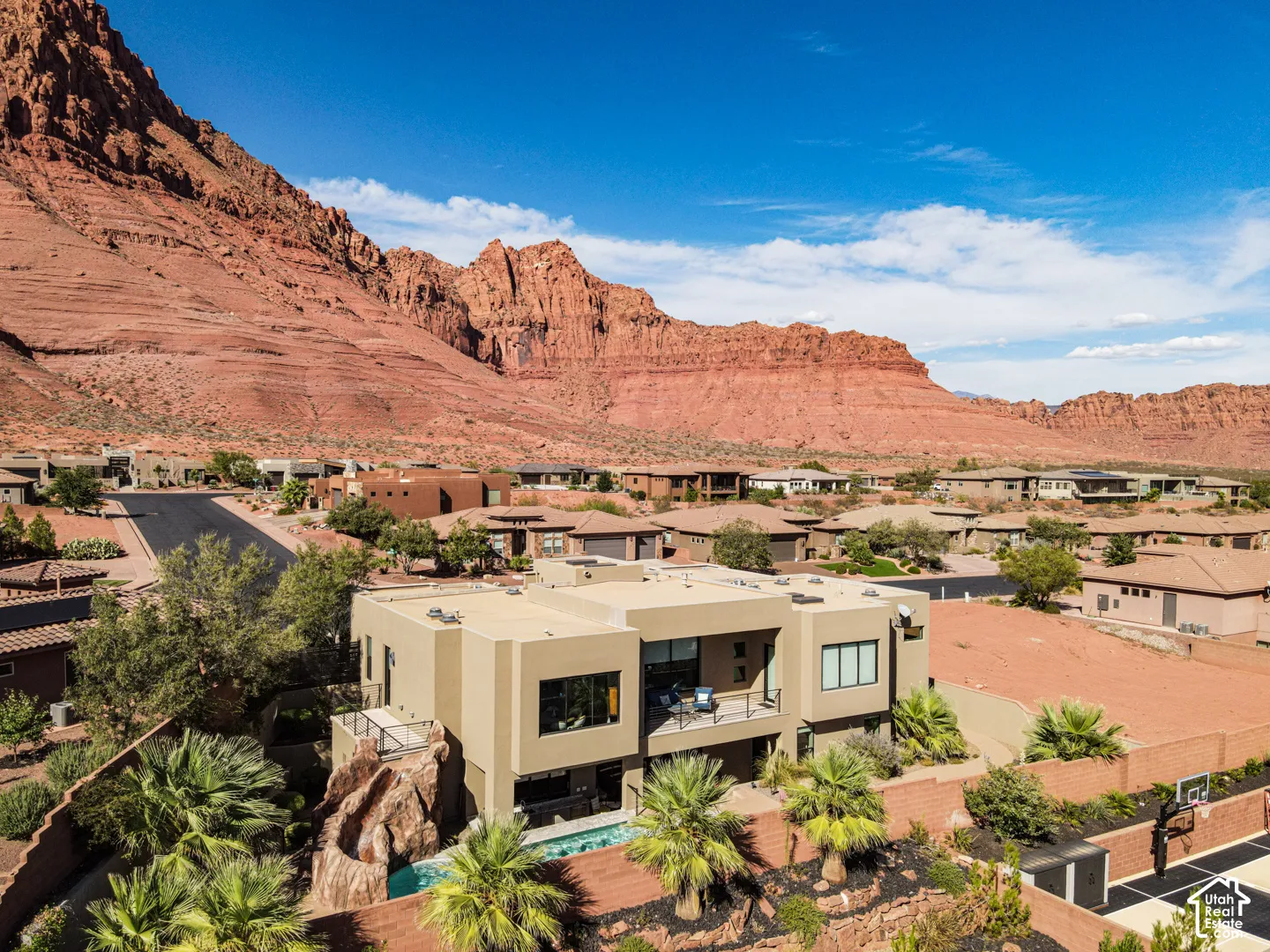 Contemporary residence with stucco exterior, multiple large windows, and a private balcony