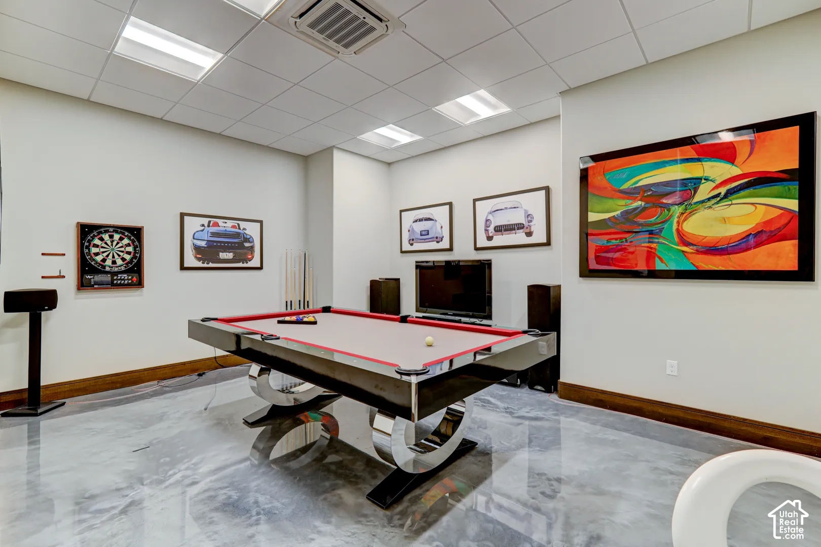 Recreation room featuring a modern pool table with chrome accents, sleek concrete-finish flooring, and recessed ceiling lighting