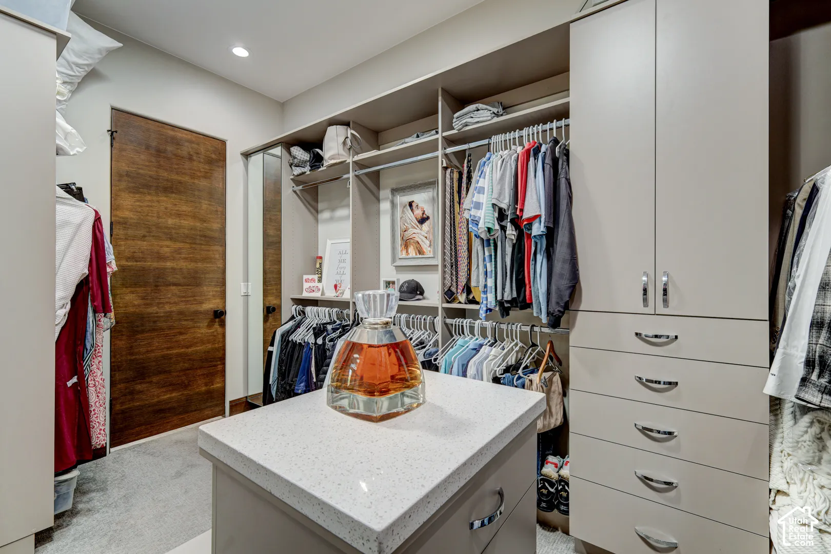 Custom closet system featuring built-in cabinetry, shelving, and hanging rods