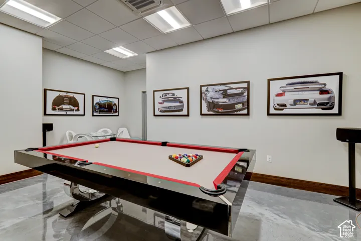 Polished concrete flooring, recessed lighting, and a drop ceiling with integrated lighting