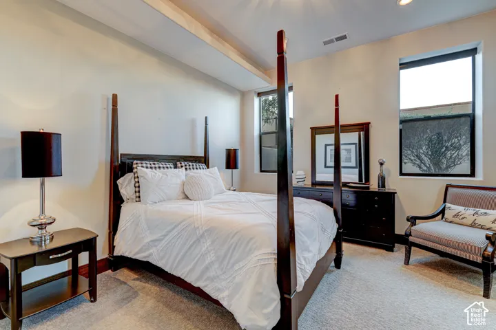 Neutral-toned walls complement the light-colored carpeting