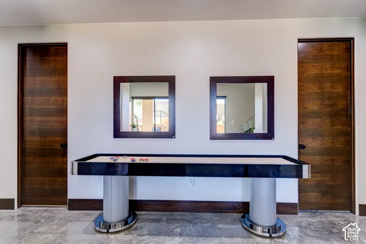Wood-finish doors, two framed mirrors, and light-colored wall paint