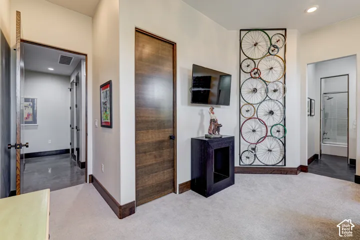 Carpeted flooring, recessed lighting, and wood-finish doors