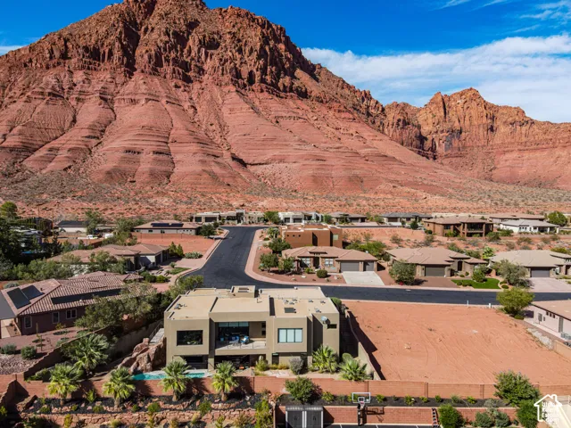 Modern desert architecture with a flat roofline, integrated outdoor balcony, and a multi-level concrete exterior