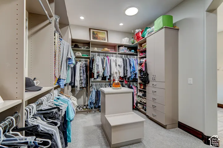 Custom closet system featuring built-in shelving, hanging rods, and cabinetry with drawers