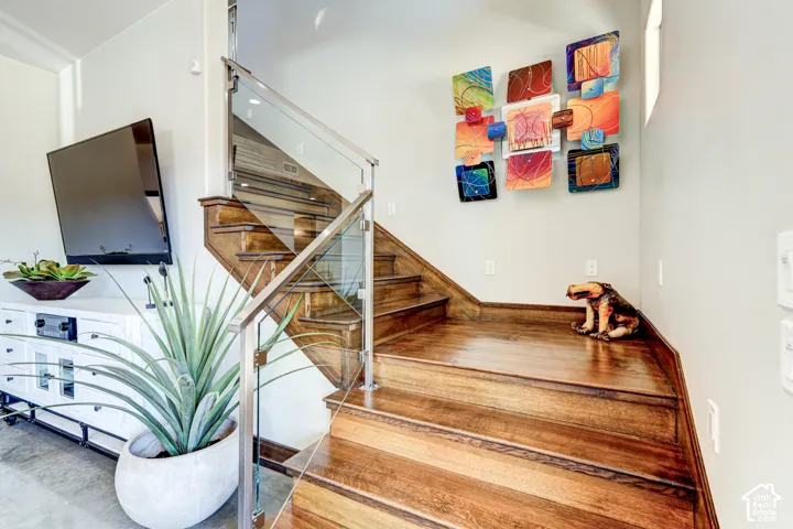 Wood-finish stairs with a glass and metal railing system