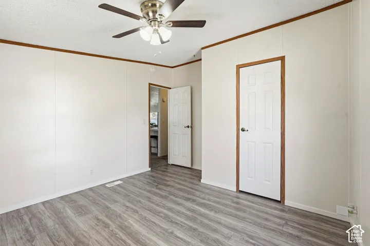 Wood-finish flooring with white paneled walls and wood trim