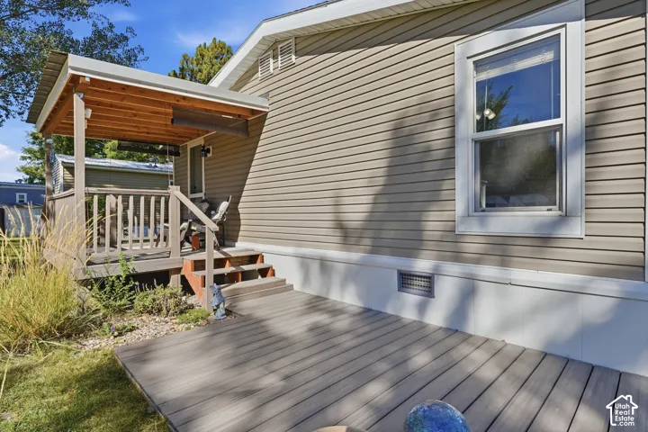 Wood-finish deck with steps leading to a covered porch with a wood ceiling