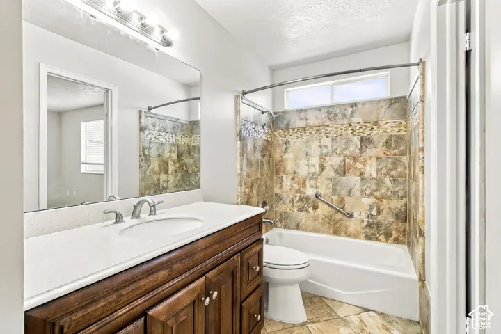 Wood-finish vanity with an integrated sink and light-colored countertop