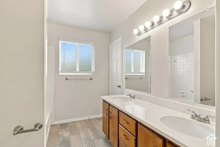 Double vanity with undermount sinks and light-toned countertops