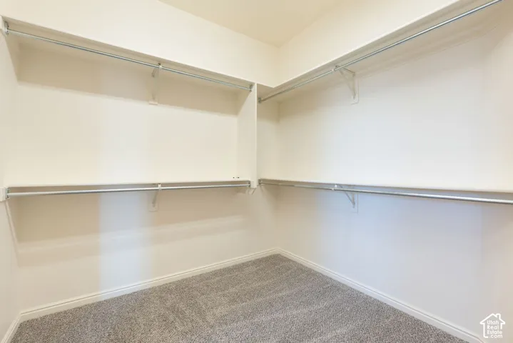 Walk-in closet with integrated shelving and hanging rods