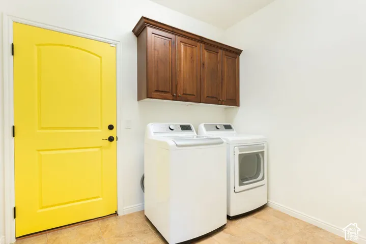 Tile flooring, white walls, and wood-finish upper cabinetry