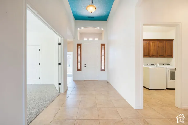 Recessed entry with tile flooring, a decorative ceiling fixture, and transom window