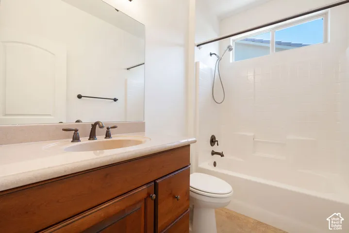 Wood-finish vanity with integrated sink, bronze-finish faucet, and coordinating hardware