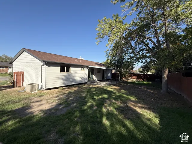 Rear exterior with horizontal siding and a brown shingle roof