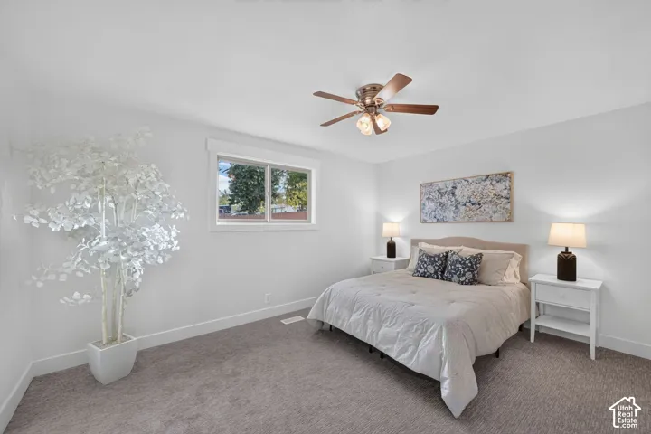 Recessed window with white trim, ceiling fan with integrated lighting, wall-to-wall carpeting, and white painted walls