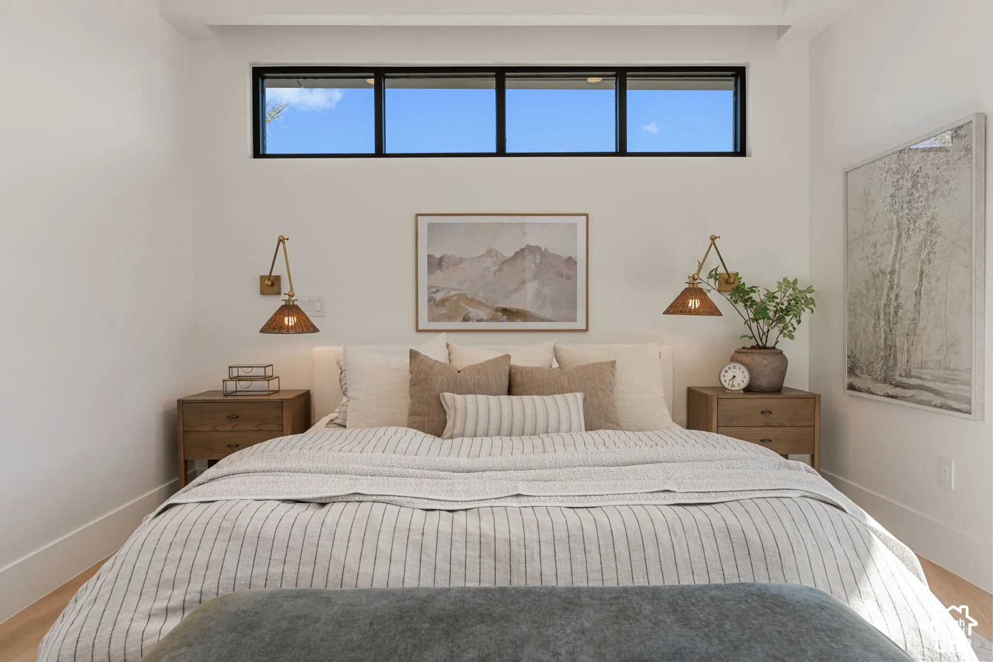 Transom windows, recessed lighting, and light wood-finish flooring