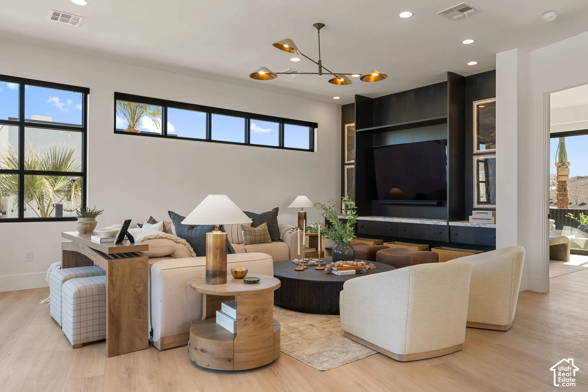Wood-finish flooring throughout, complemented by a built-in media center with dark cabinetry