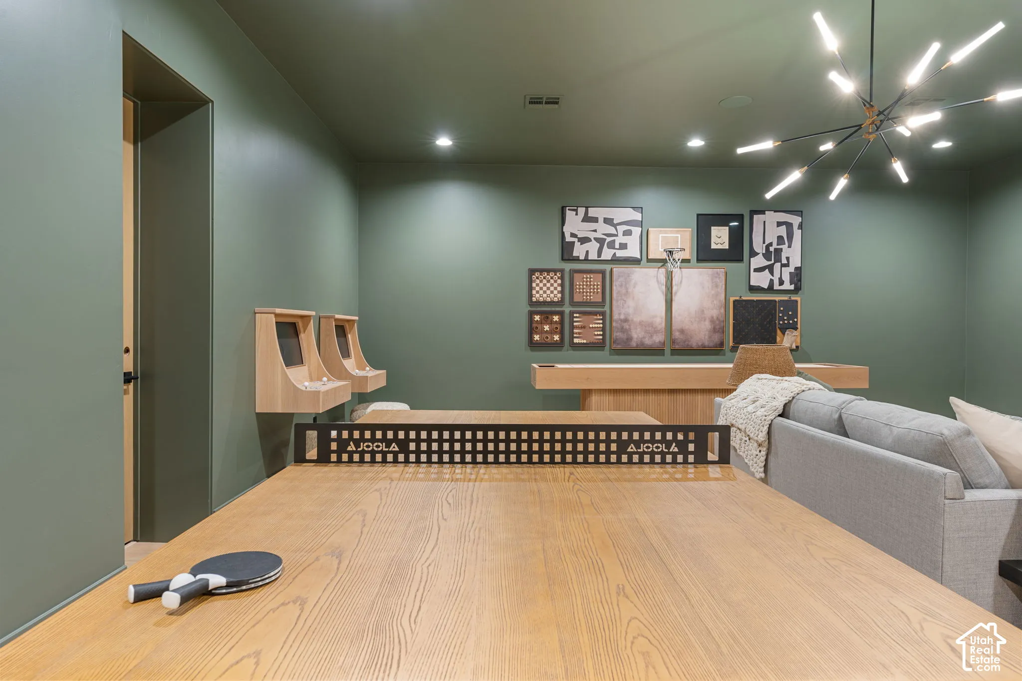 Recreation room featuring wood-finish flooring, recessed lighting, and a modern sputnik chandelier
