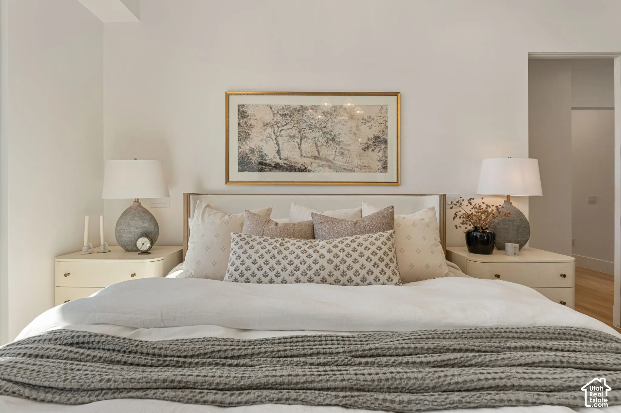 Upholstered headboard with a light wood frame, flanked by integrated nightstands featuring two drawers each