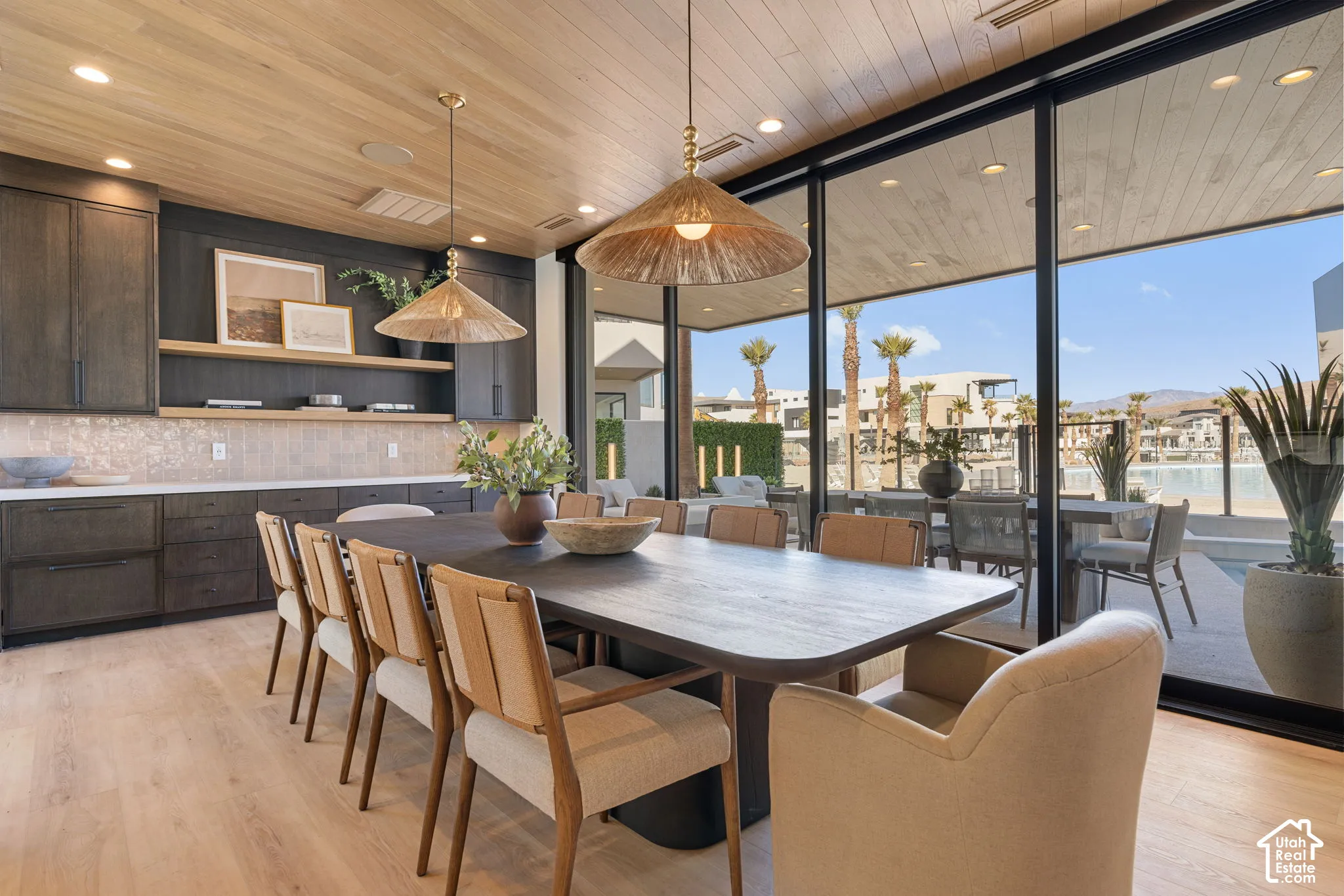 Wood-finish ceiling with recessed lighting and two pendant fixtures