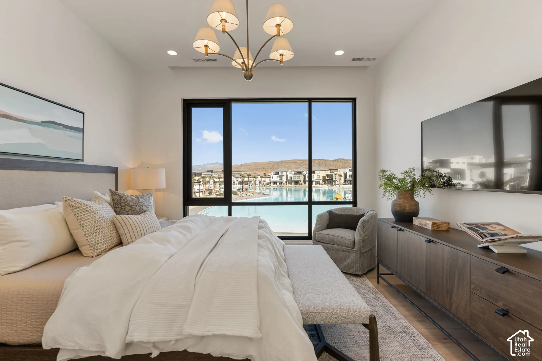 Floor-to-ceiling window, wood-finish flooring, recessed lighting, chandelier, and a built-in media console