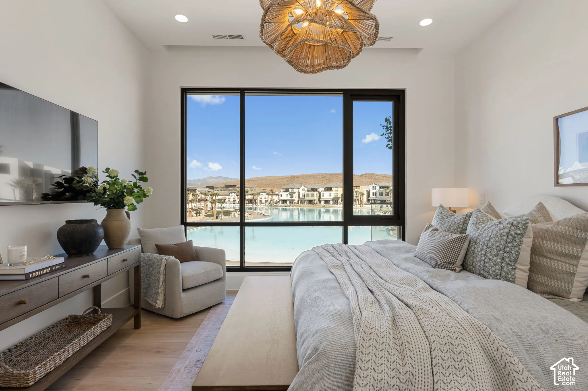 Expansive window framing a waterscape and distant hills