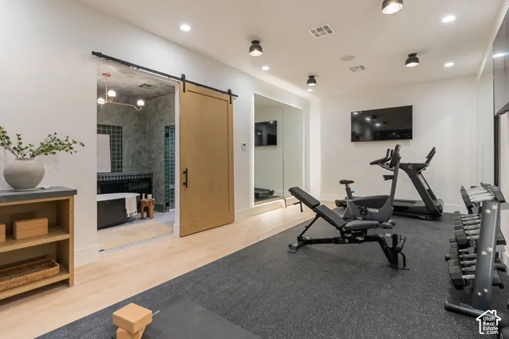 Dedicated fitness space with rubber flooring and full-height mirrors