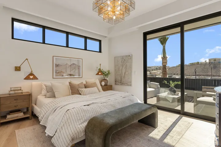 Recessed lighting, light wood-finish flooring, and a contemporary chandelier