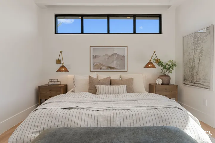 Transom windows, recessed lighting, and light wood-finish flooring