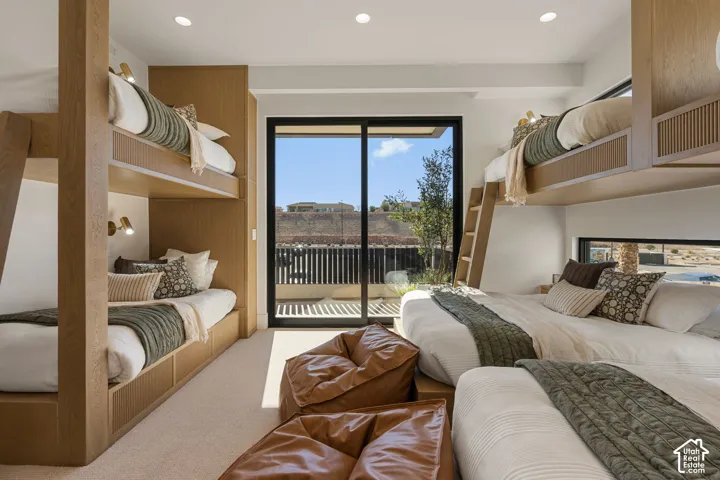 Integrated wood-finish bunk beds, recessed lighting, expansive sliding glass door, and a built-in window