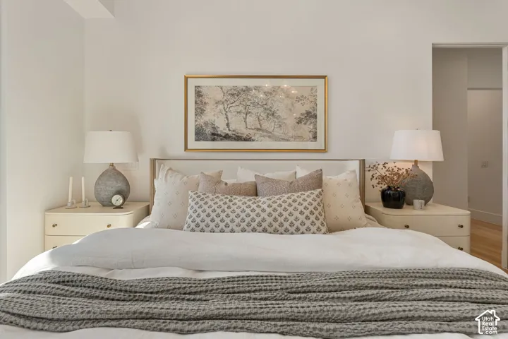 Upholstered headboard with a light wood frame, flanked by integrated nightstands featuring two drawers each