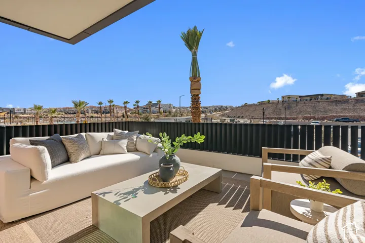 Outdoor patio featuring a concrete hardscape, a contemporary privacy fence, and an overhead architectural element