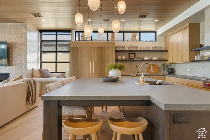 Integrated kitchen island with a built-in sink, gold-finish faucet, and substantial countertop